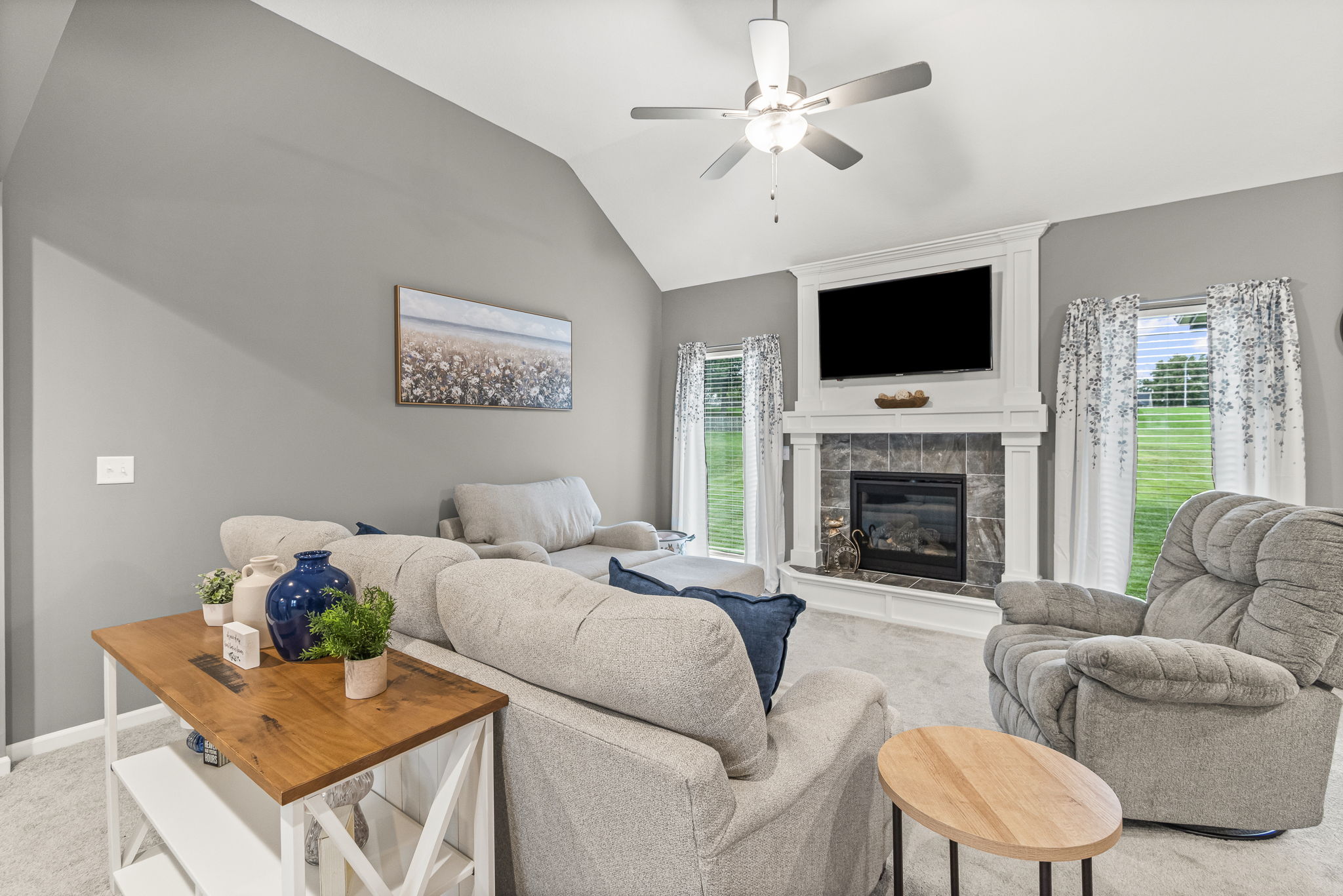 Living room with gas fireplace and vaulted ceiling