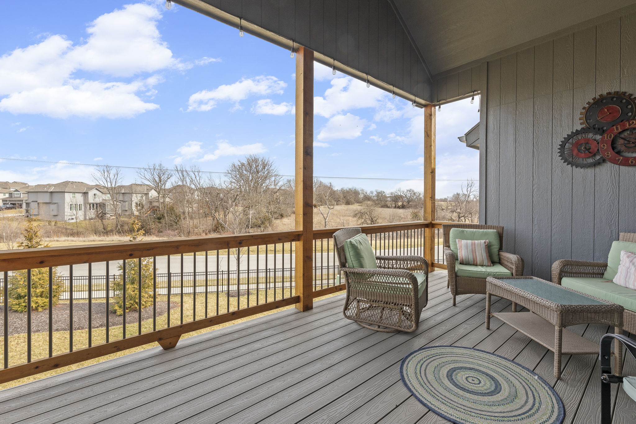 Covered deck overlooking the fenced backyard
