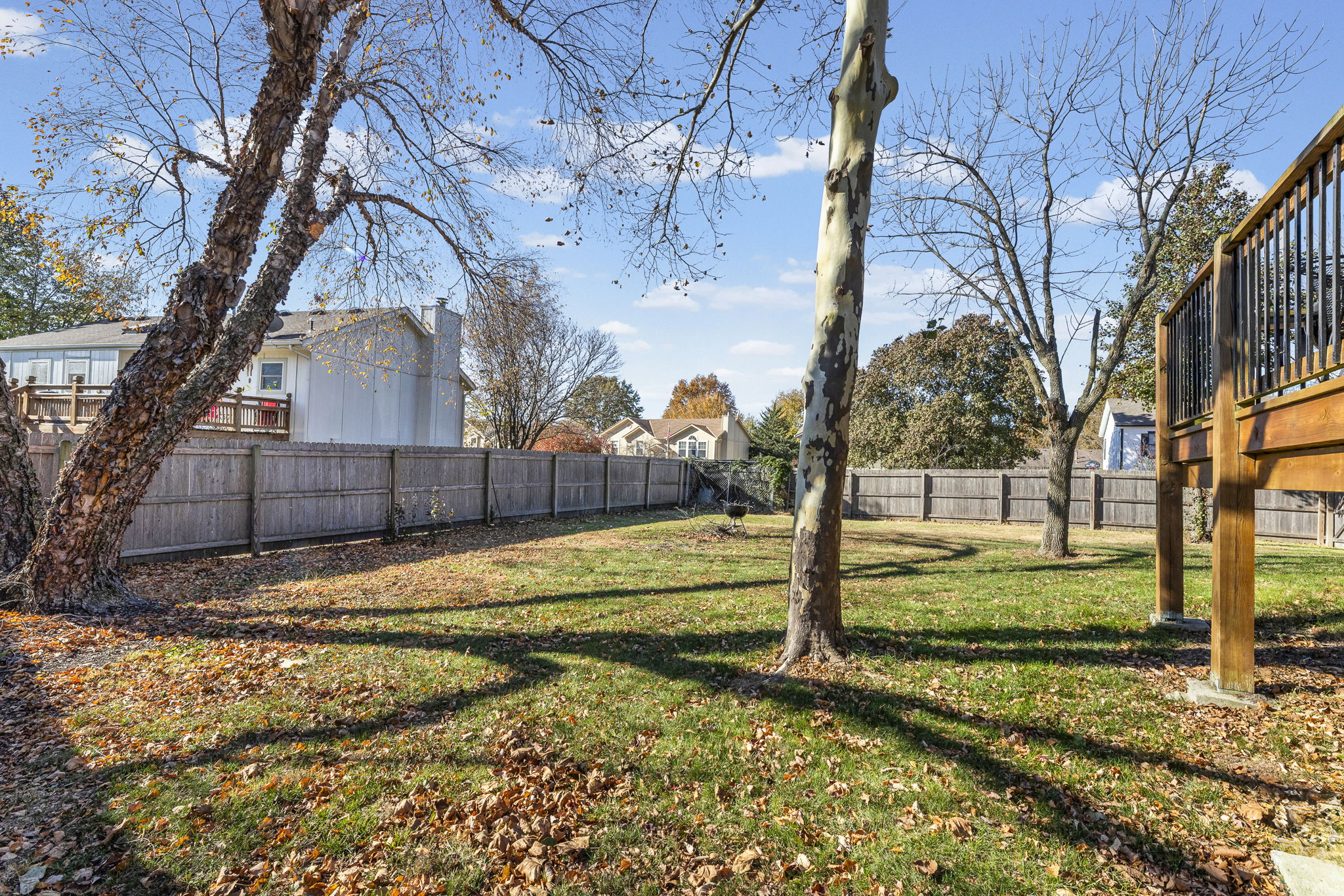 Fenced backyard with mature trees