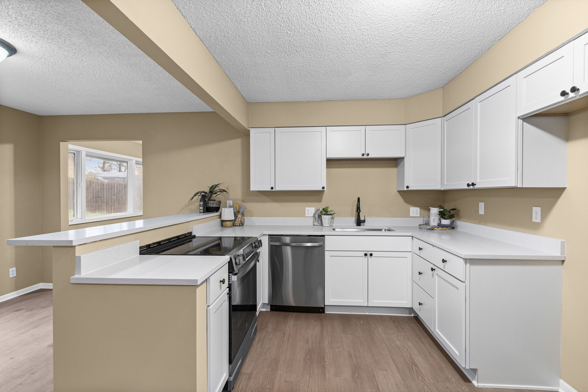 Newly remodeled kitchen with white cabinets and stainless steel