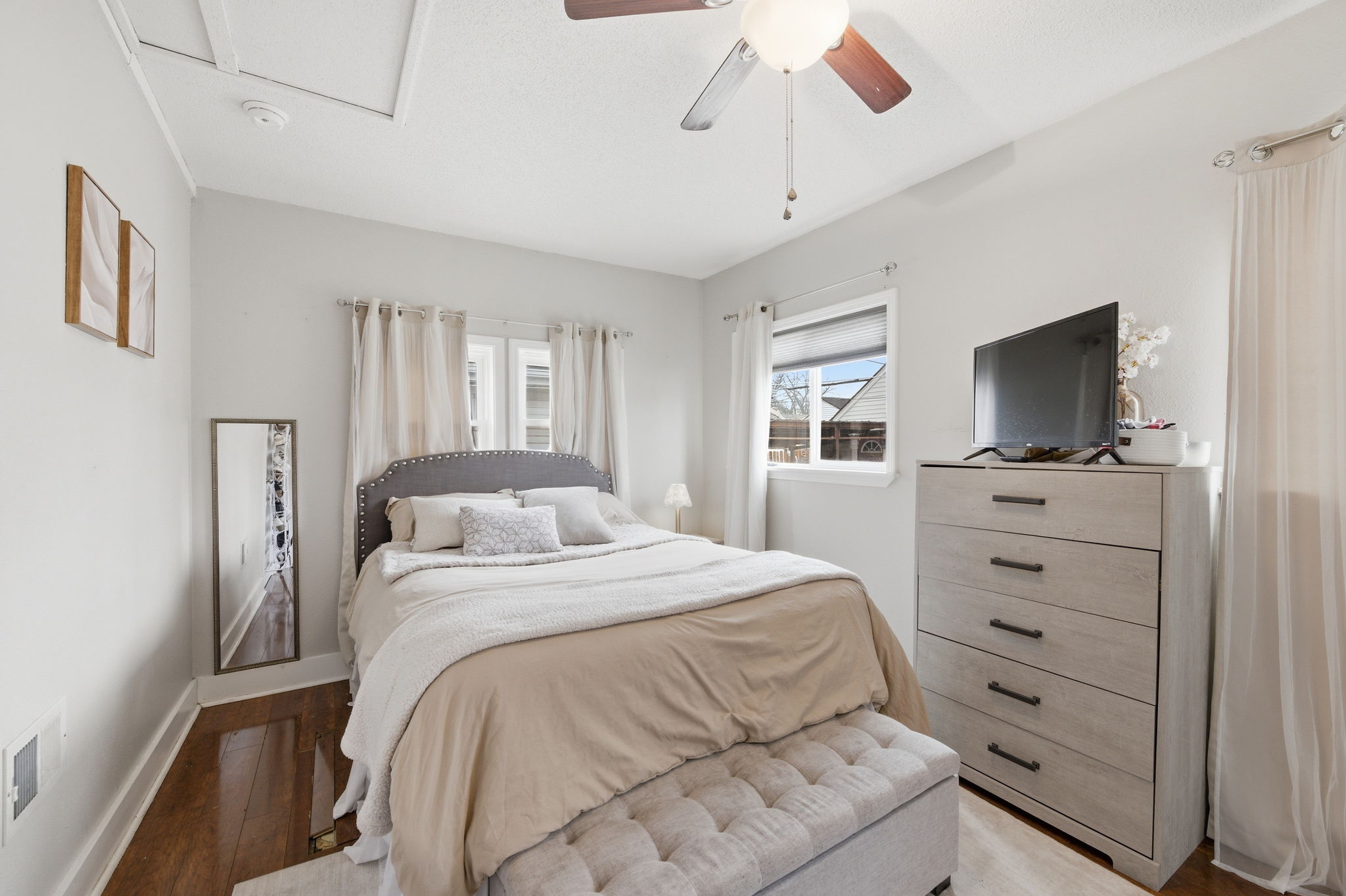 Comfortable primary bedroom with natural light