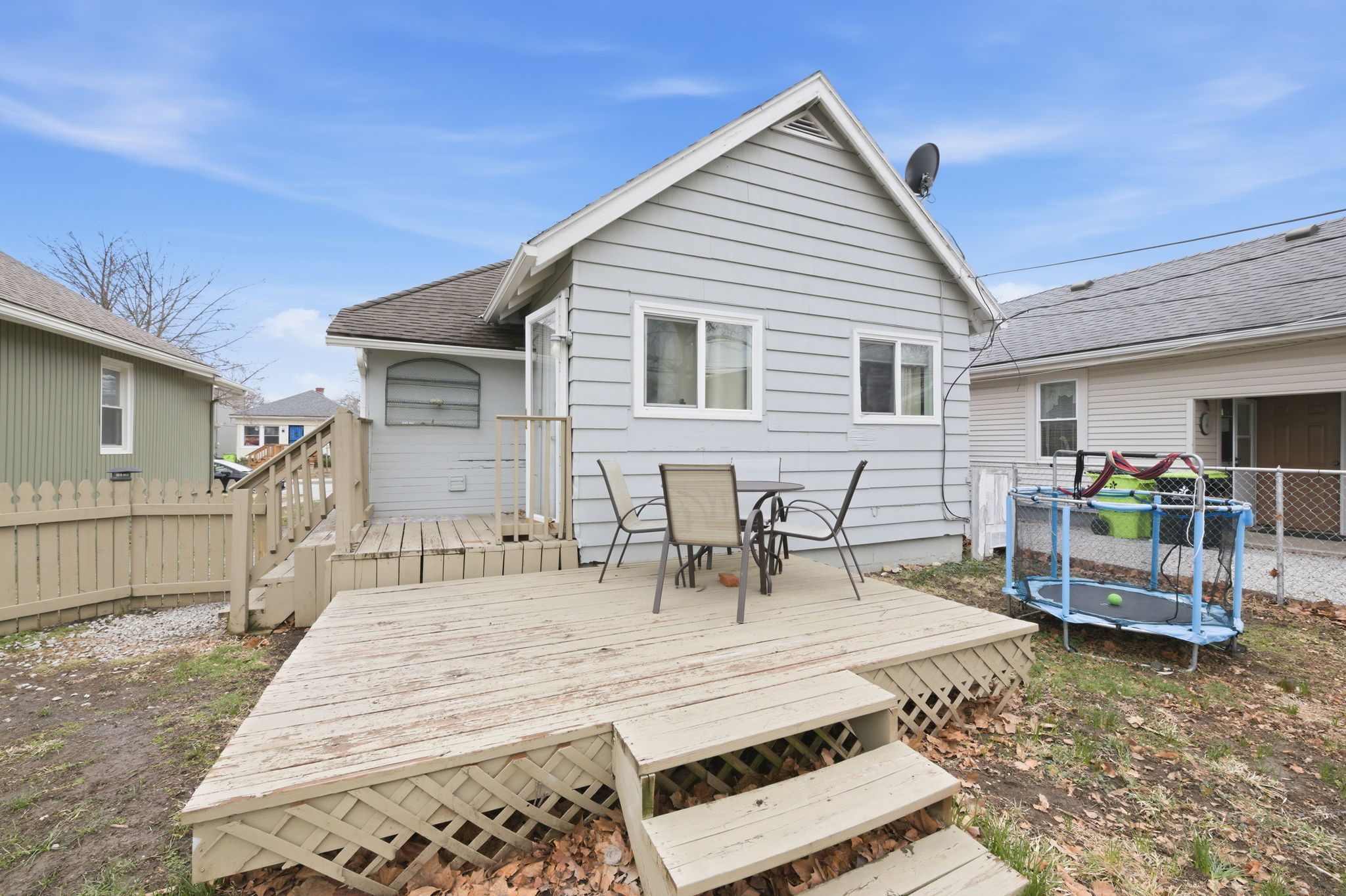 Fenced backyard with a wood deck for grilling