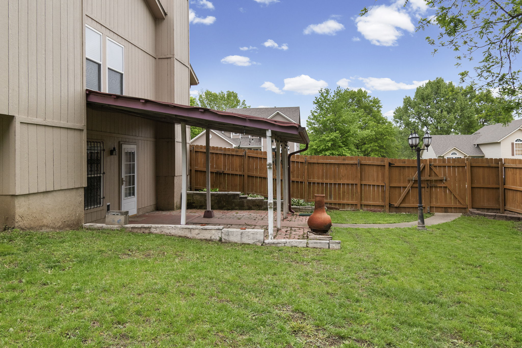 Covered patio for shade over the fenced backyard