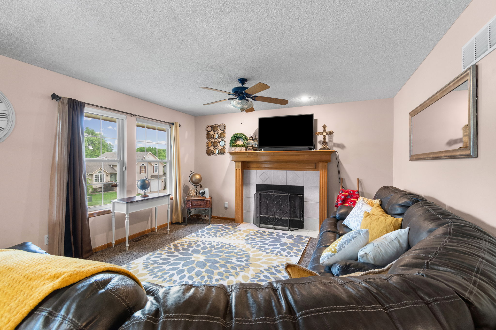 Great room anchored by a gas fireplace on the main level