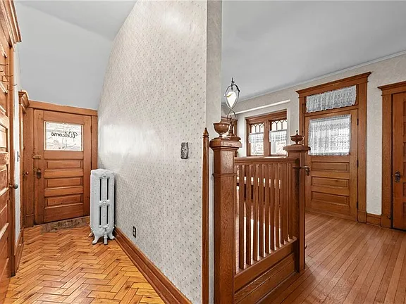 Formal parlor with period fireplace and rich hardwood floors