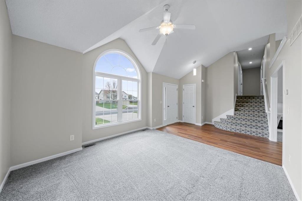 Vaulted great room lit by an oversized arched window