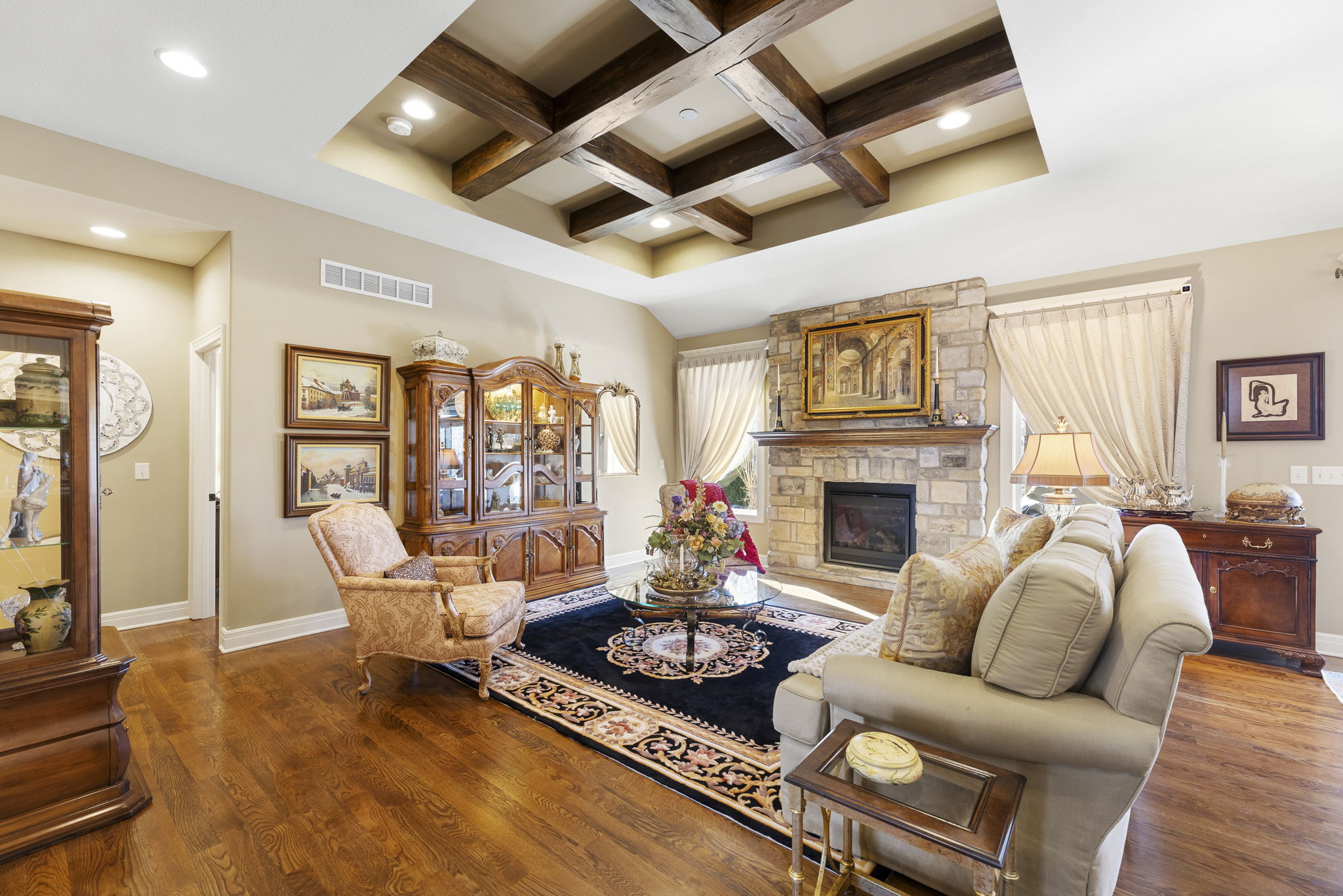 Great room with gas fireplace and beamed, beveled ceilings