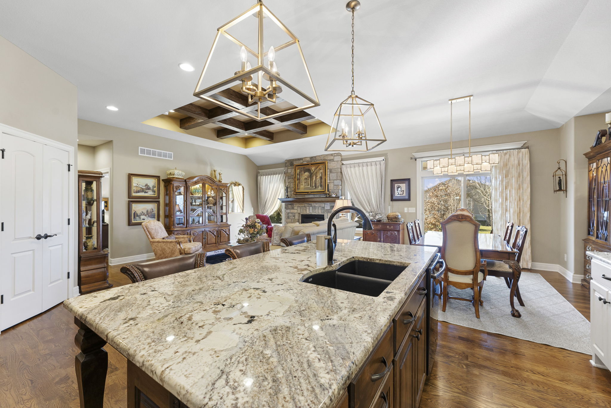 Granite island kitchen with double ovens and walk-in pantries