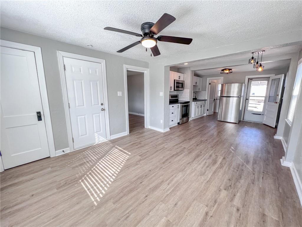 Open living-to-kitchen layout with luxury vinyl plank floors