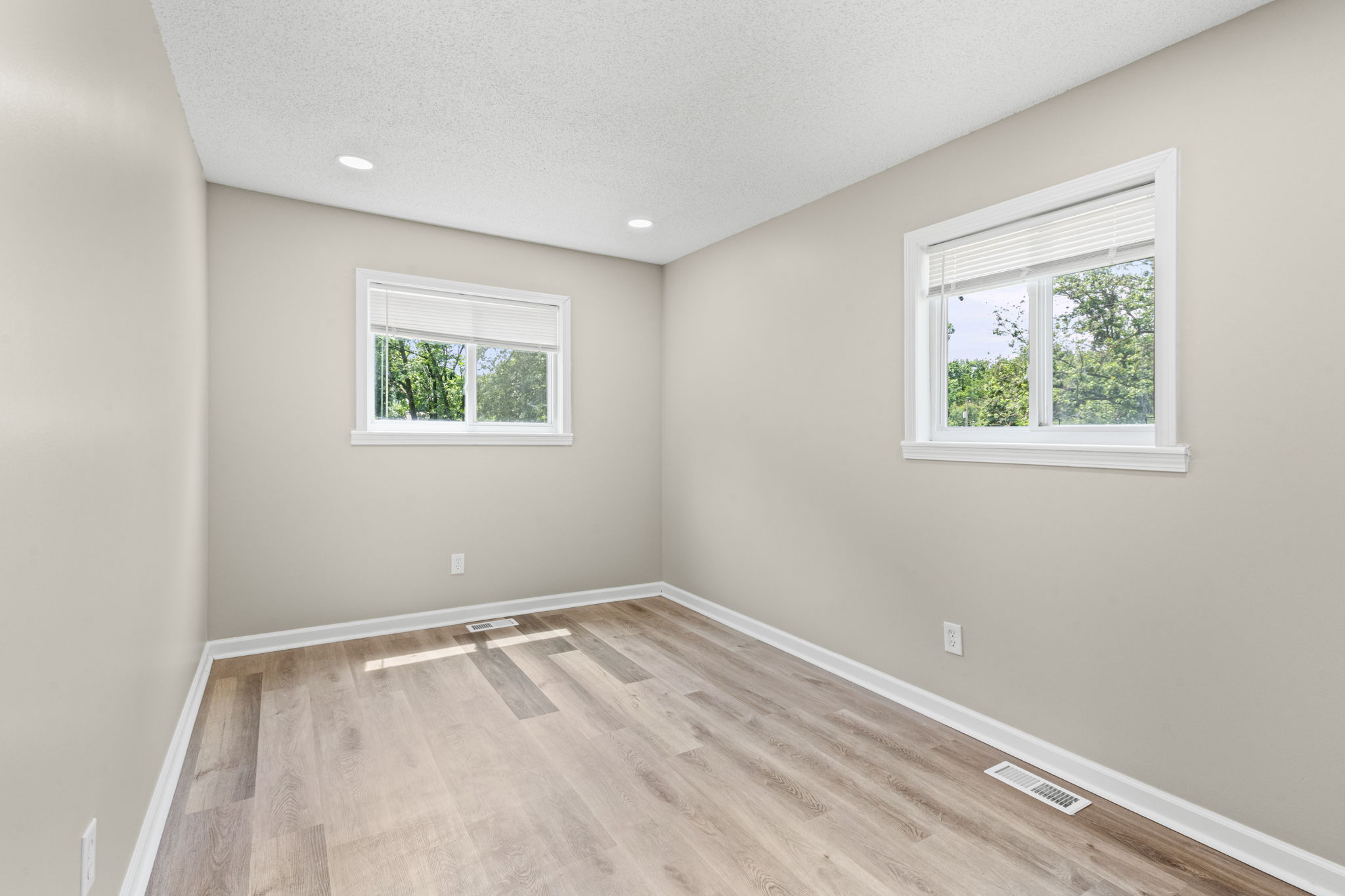 Main-level bedroom with two windows