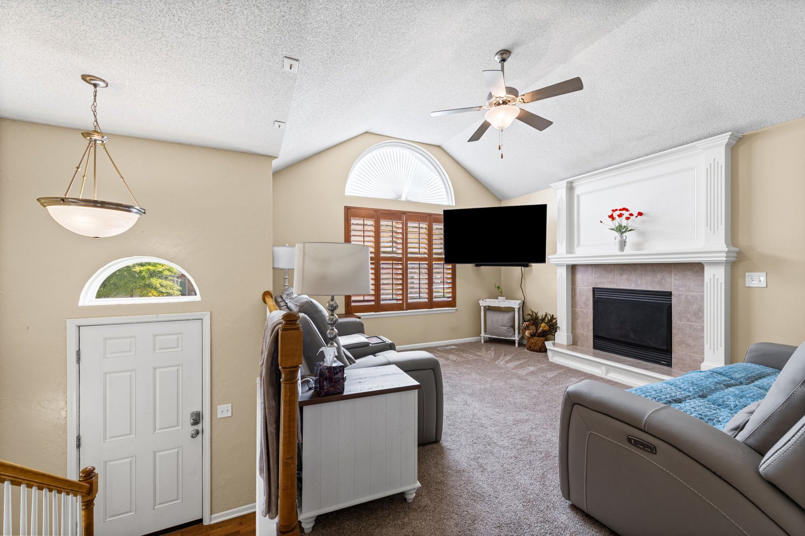 Living room with vaulted ceilings and fireplace at 1700 Debrah Drive