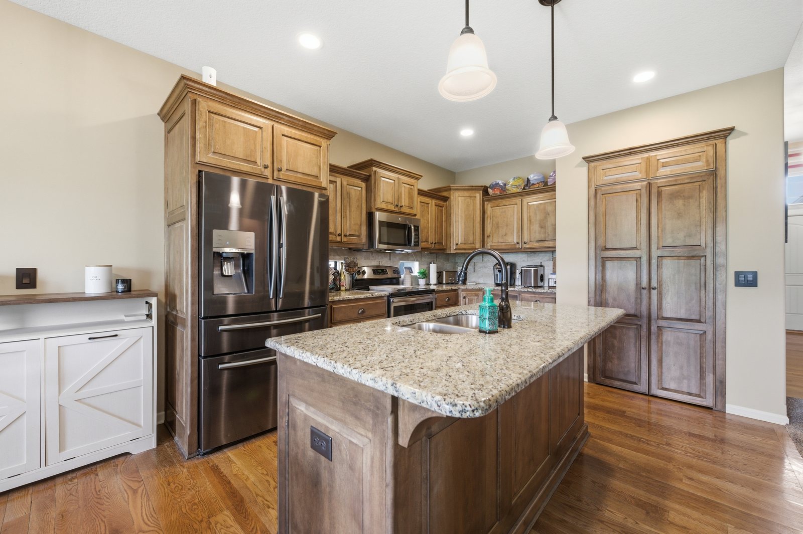 Kitchen with large island, granite countertops and custom cabinetry