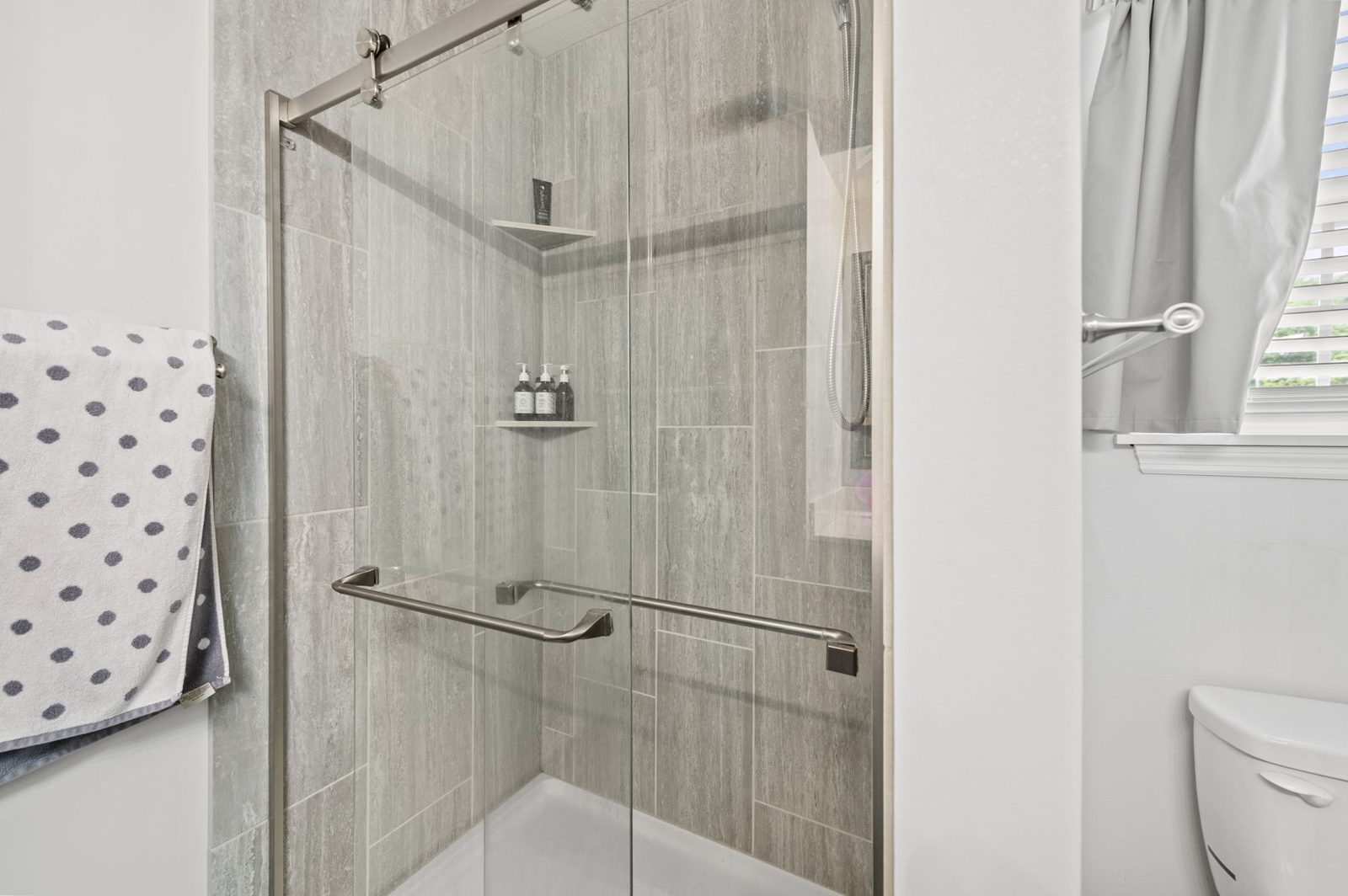 Primary bath with tiled walk-in shower at 1700 Todd Street